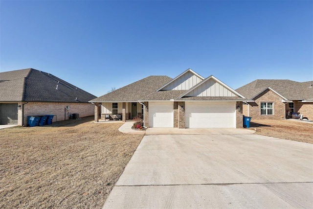 view of front of property with a garage, a porch, and a front yard