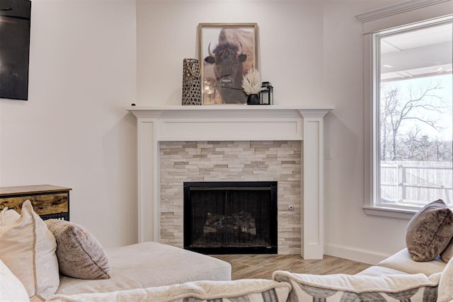 interior space with a tile fireplace and light hardwood / wood-style floors