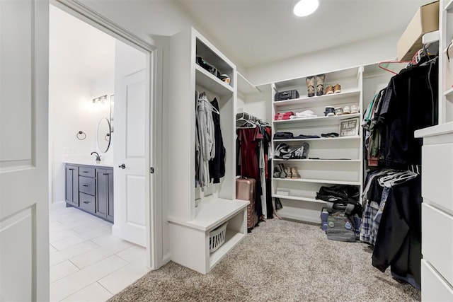 walk in closet featuring light carpet