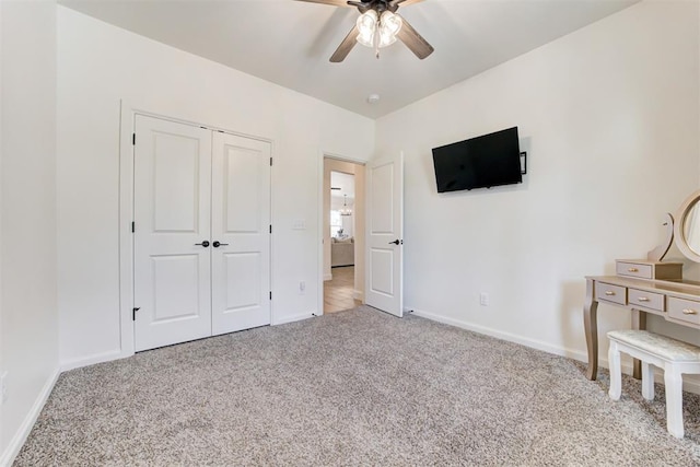 carpeted bedroom with a closet and ceiling fan