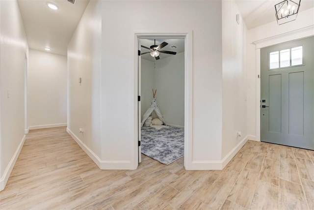 foyer entrance with an inviting chandelier and light wood-type flooring