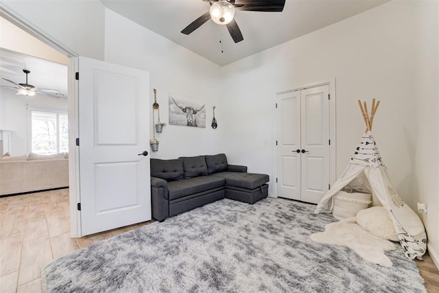 living room with hardwood / wood-style floors and ceiling fan