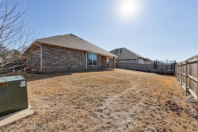 rear view of house with a trampoline