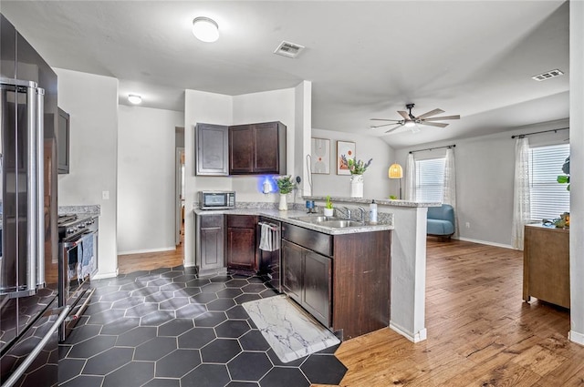 kitchen featuring dark brown cabinetry, sink, kitchen peninsula, ceiling fan, and stainless steel appliances