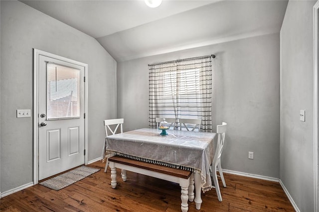 dining area with lofted ceiling and hardwood / wood-style floors