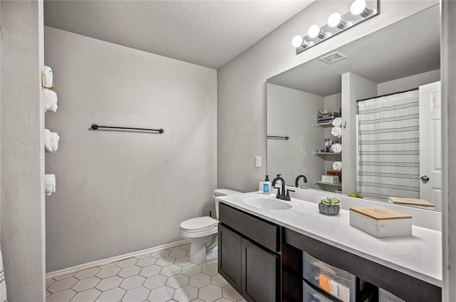 bathroom featuring vanity and toilet