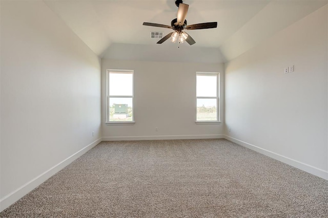 carpeted empty room featuring ceiling fan and vaulted ceiling