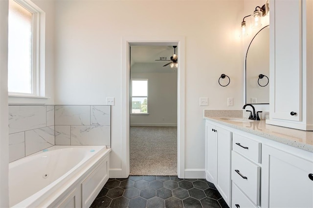 bathroom featuring vanity, ceiling fan, tile patterned floors, and a bathing tub