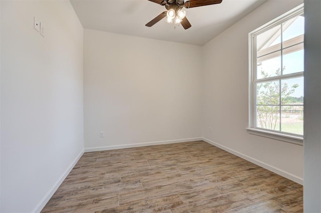 empty room with ceiling fan and light hardwood / wood-style floors