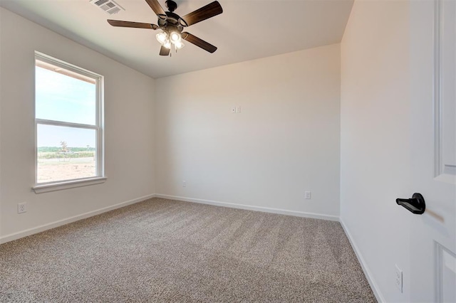 carpeted spare room with ceiling fan