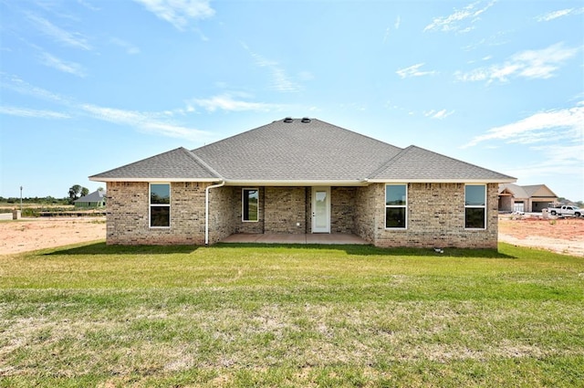 back of property with a patio area and a lawn