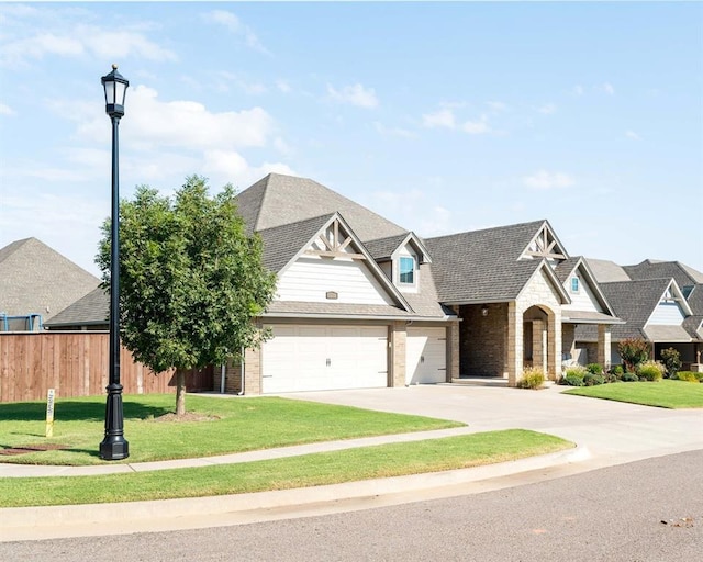 view of front of home with a garage and a front lawn