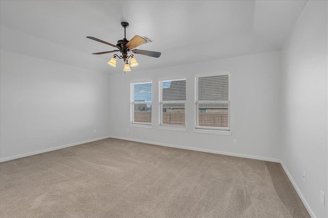 unfurnished room featuring light colored carpet and ceiling fan