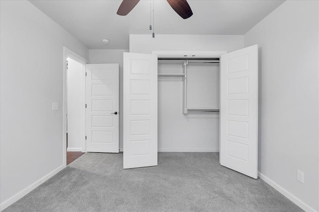 unfurnished bedroom featuring light carpet, ceiling fan, and a closet