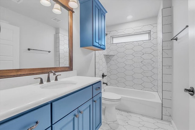 full bathroom featuring vanity, tiled shower / bath combo, and toilet