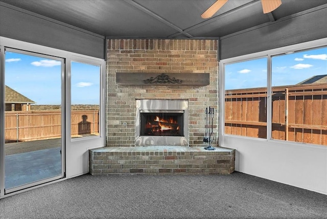 unfurnished sunroom with a brick fireplace