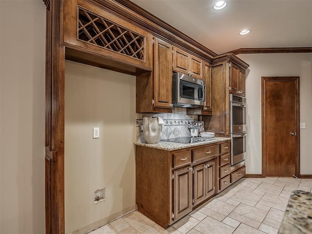 kitchen featuring ornamental molding, appliances with stainless steel finishes, light stone countertops, and decorative backsplash