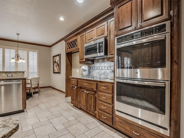 kitchen with light stone counters, tasteful backsplash, hanging light fixtures, ornamental molding, and appliances with stainless steel finishes