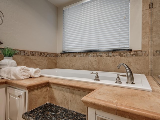 bathroom featuring tiled bath