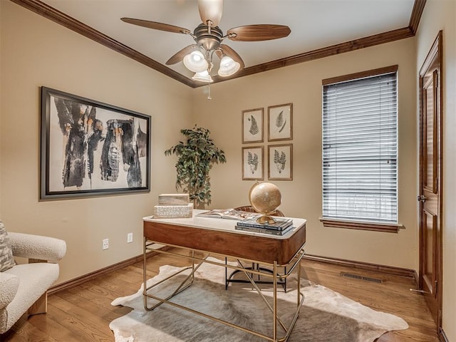 office featuring ceiling fan, ornamental molding, and light hardwood / wood-style flooring