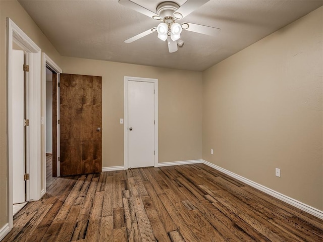 unfurnished room featuring dark hardwood / wood-style floors and ceiling fan