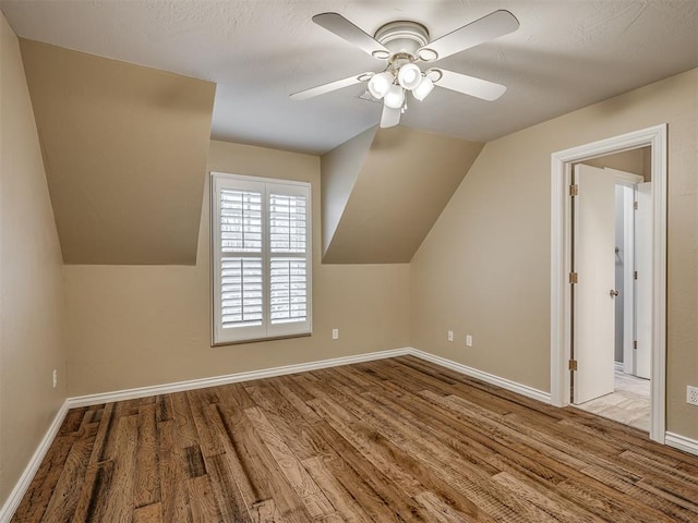 bonus room with ceiling fan, lofted ceiling, and light hardwood / wood-style floors