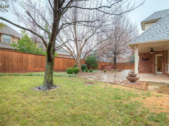 view of yard with a patio and ceiling fan