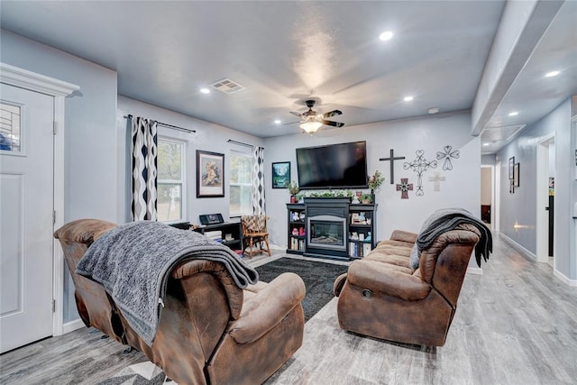 living room featuring ceiling fan and light wood-type flooring