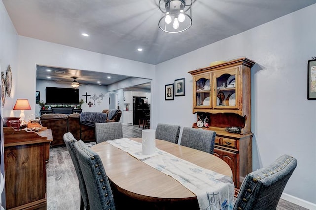 dining space with hardwood / wood-style flooring and ceiling fan