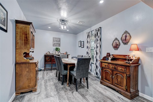 dining space with light hardwood / wood-style flooring