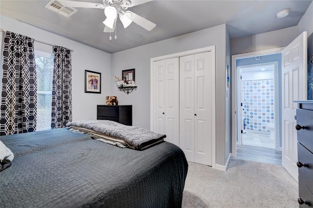 carpeted bedroom featuring ceiling fan and a closet