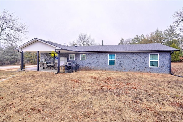 back of property with a patio