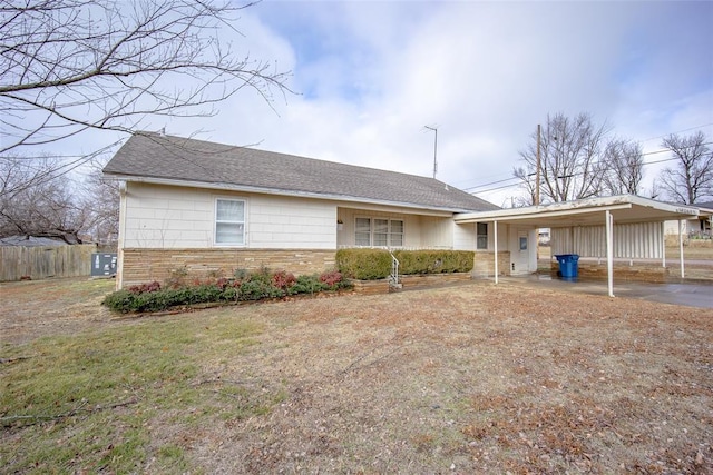 ranch-style home with a carport and a front lawn