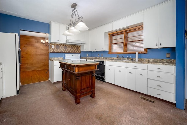 kitchen featuring range, black dishwasher, white refrigerator, white cabinets, and a kitchen island