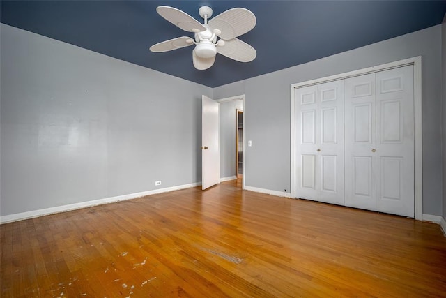 unfurnished bedroom with ceiling fan, a closet, and light hardwood / wood-style flooring