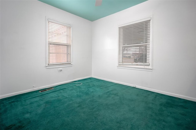 unfurnished room with dark carpet