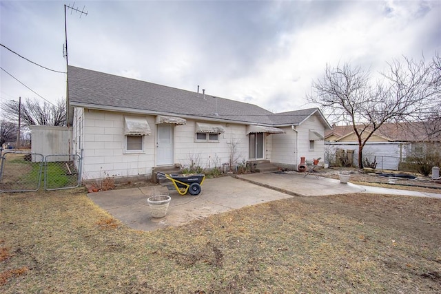 view of front of home with a front lawn and a patio