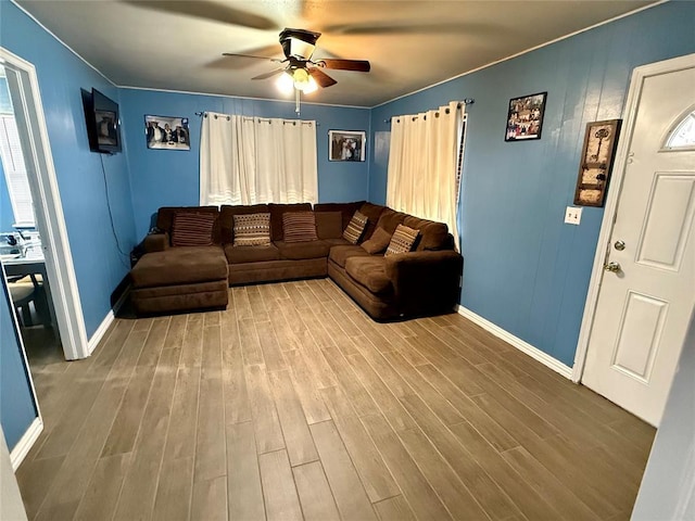 living room with wood-type flooring and ceiling fan