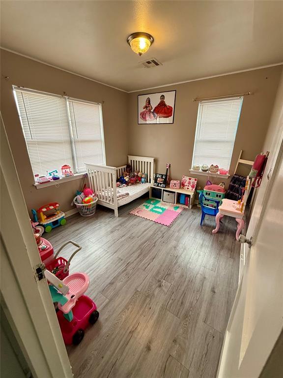 bedroom with hardwood / wood-style flooring