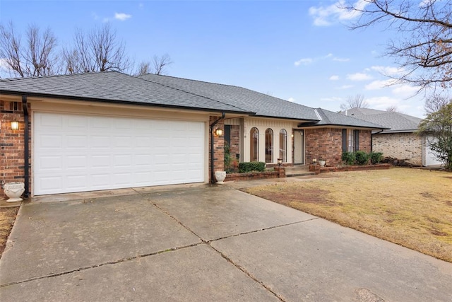 single story home featuring a garage and a front lawn