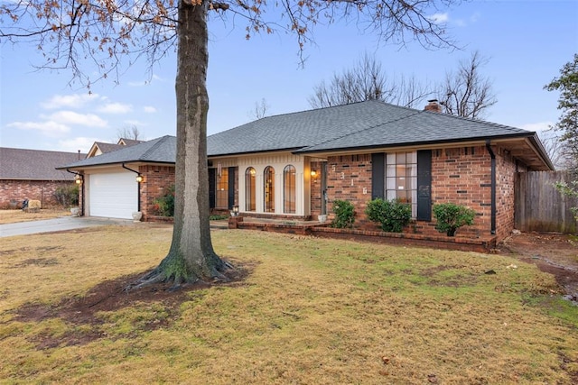 ranch-style house featuring a garage and a front lawn