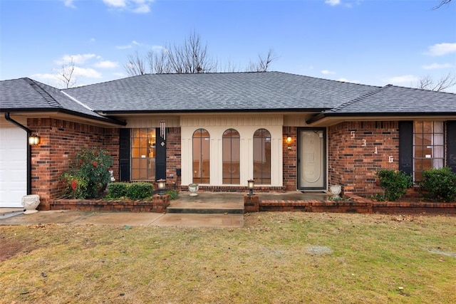 ranch-style home featuring a garage and a front yard