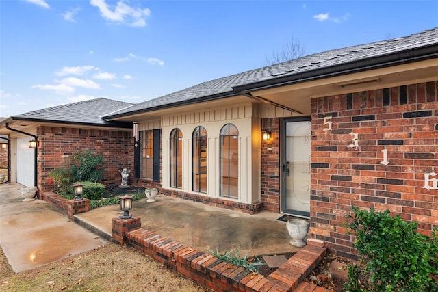 view of exterior entry with a garage