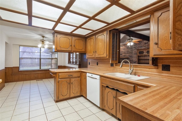 kitchen with sink, light tile patterned floors, butcher block counters, white dishwasher, and kitchen peninsula