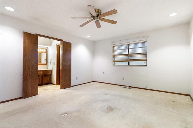 unfurnished bedroom with light carpet, connected bathroom, and ceiling fan