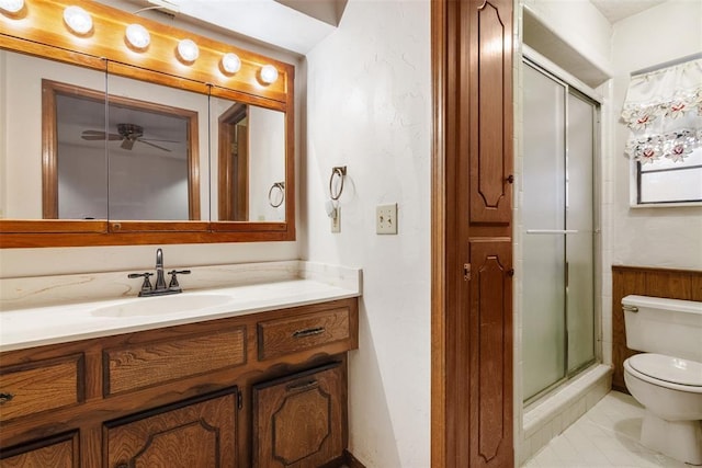 bathroom with an enclosed shower, vanity, and toilet