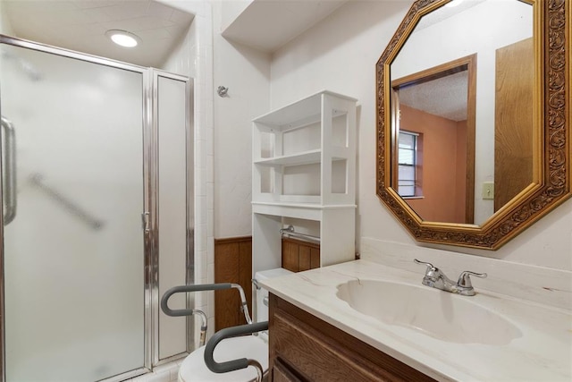 bathroom featuring vanity and a shower with door