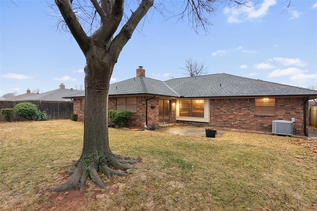 back of house with a lawn, central air condition unit, and a patio area