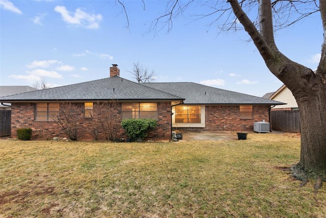 back of house with cooling unit, a yard, and a patio area