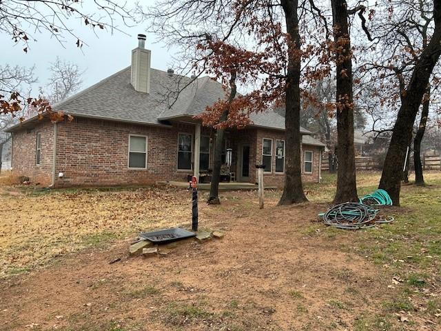 rear view of property with a lawn